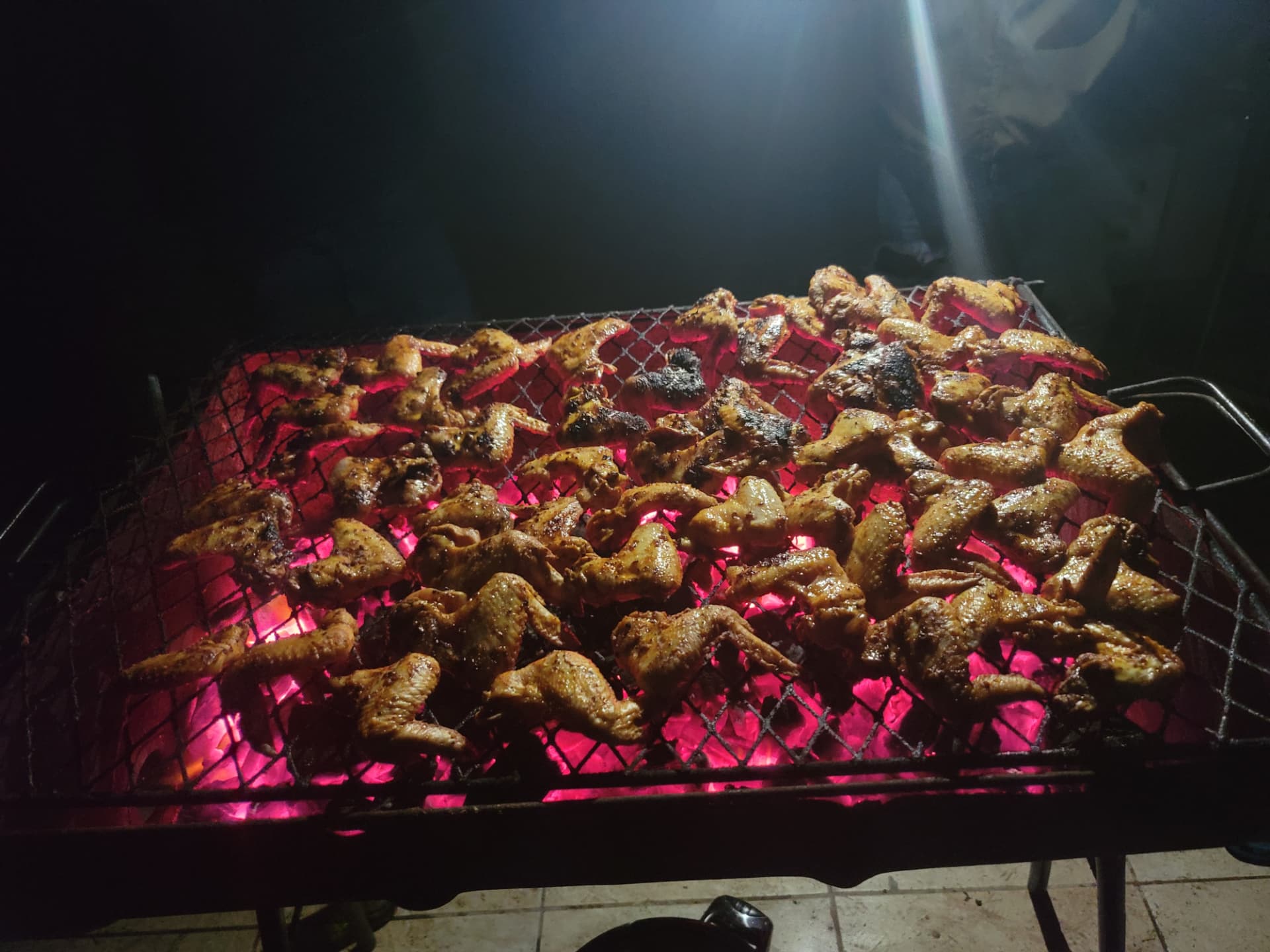 Chicken wings over red-hot charcoal
